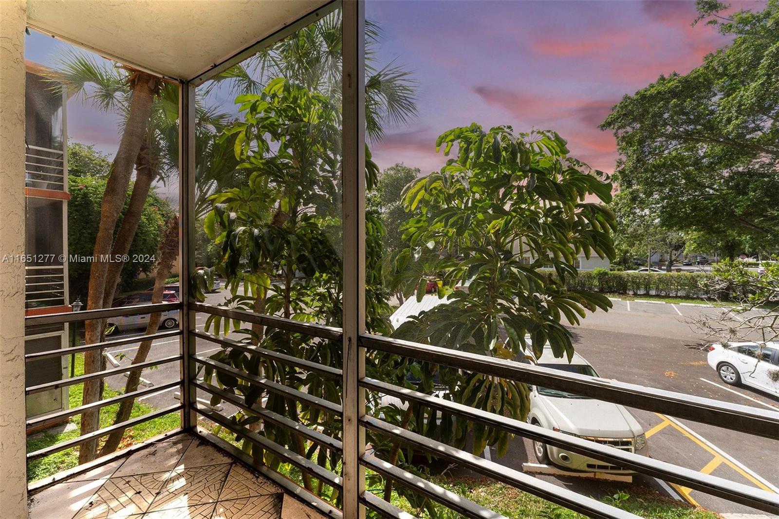 a view of a balcony with potted plants