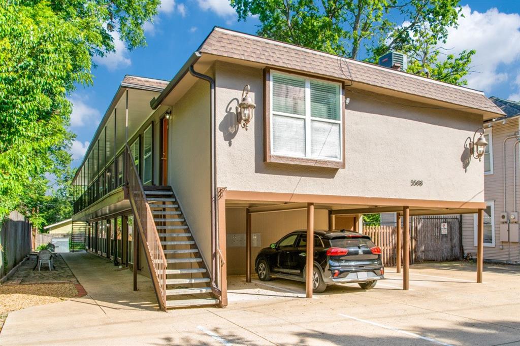 a view of a house with a patio and a yard