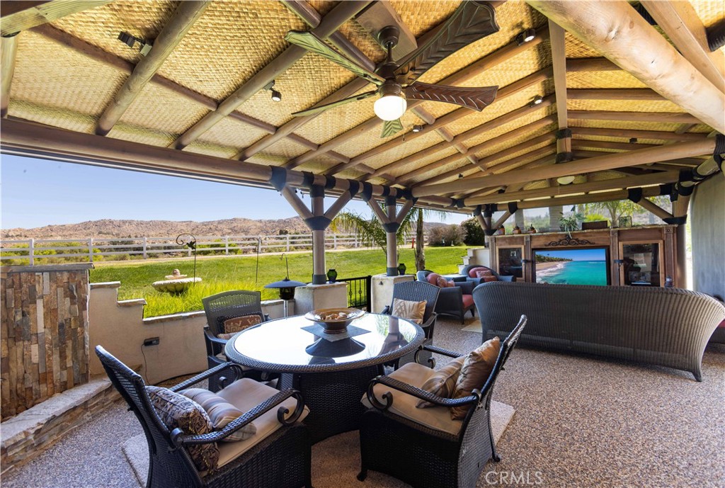 a view of a patio with a table chairs and a backyard