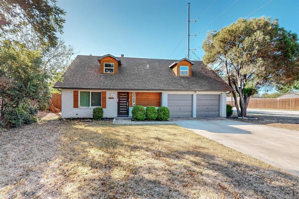 a view of a house with a yard and garage