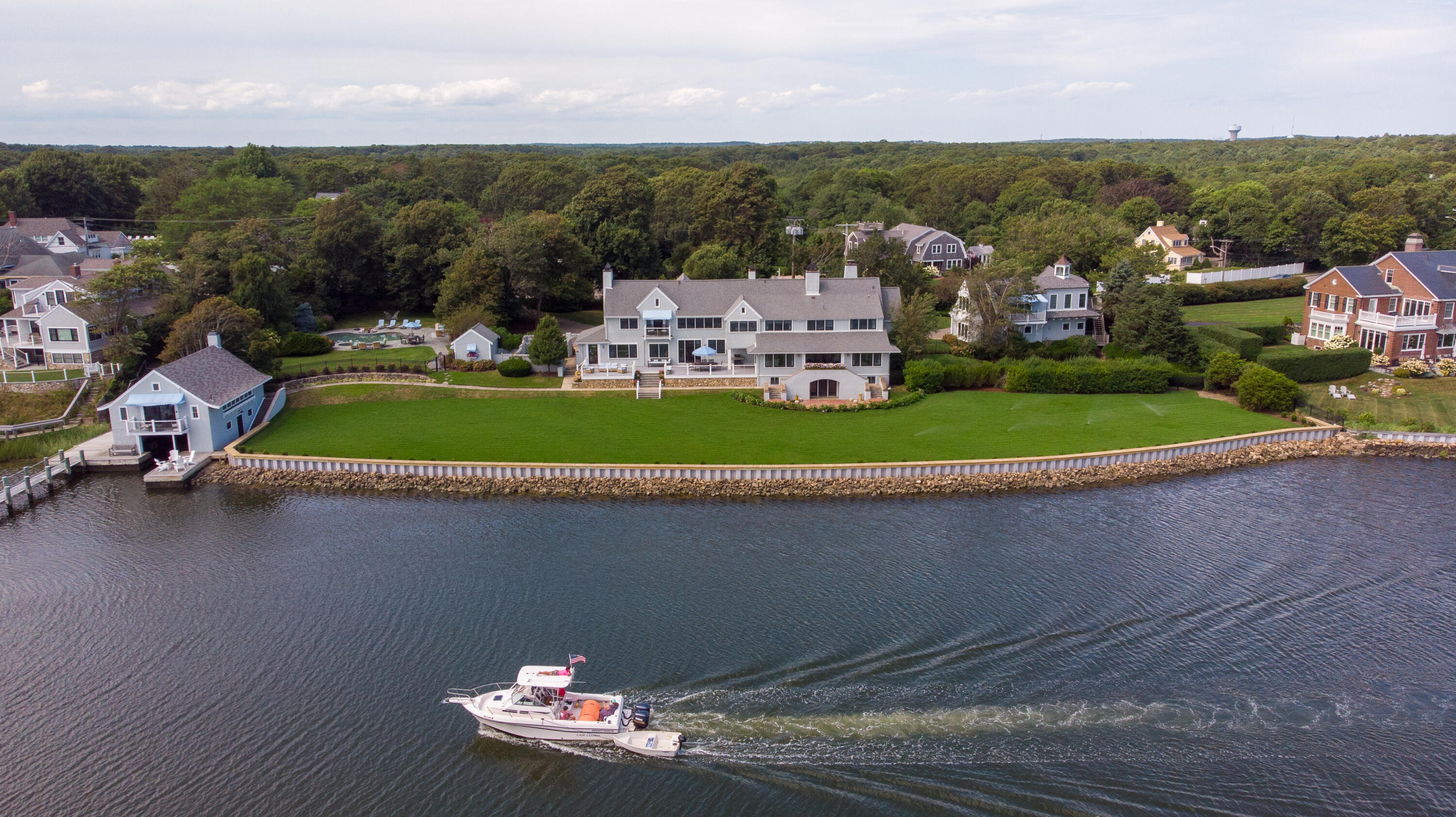 an aerial view of a house with a garden and lake view