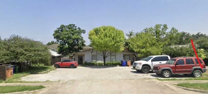 a front view of a house with a garden and parking