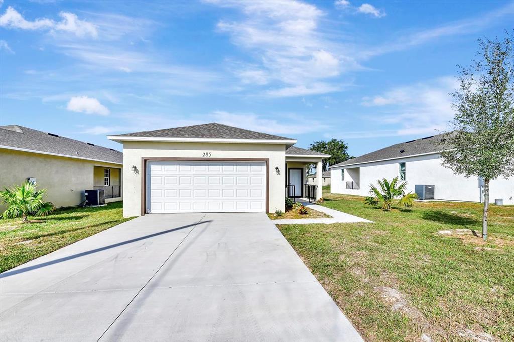 a view of a house with a yard and garage