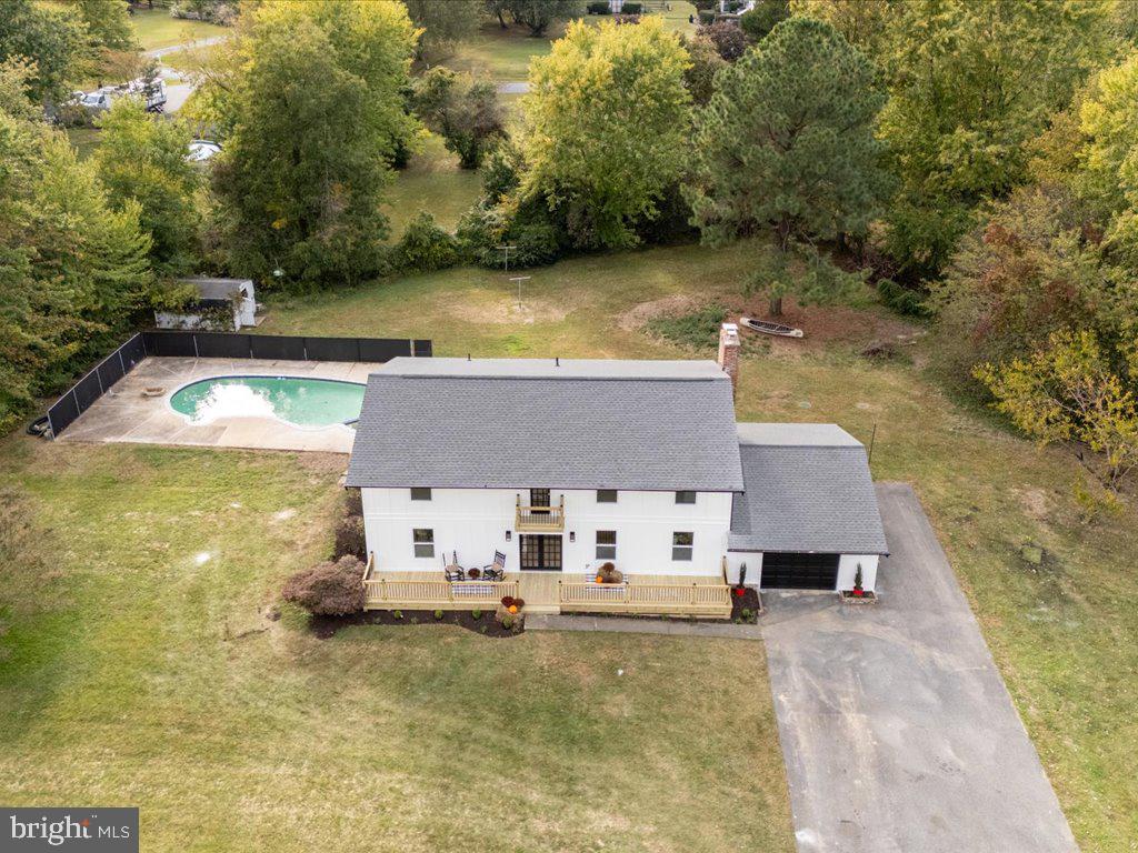 a aerial view of a house with swimming pool and sitting area