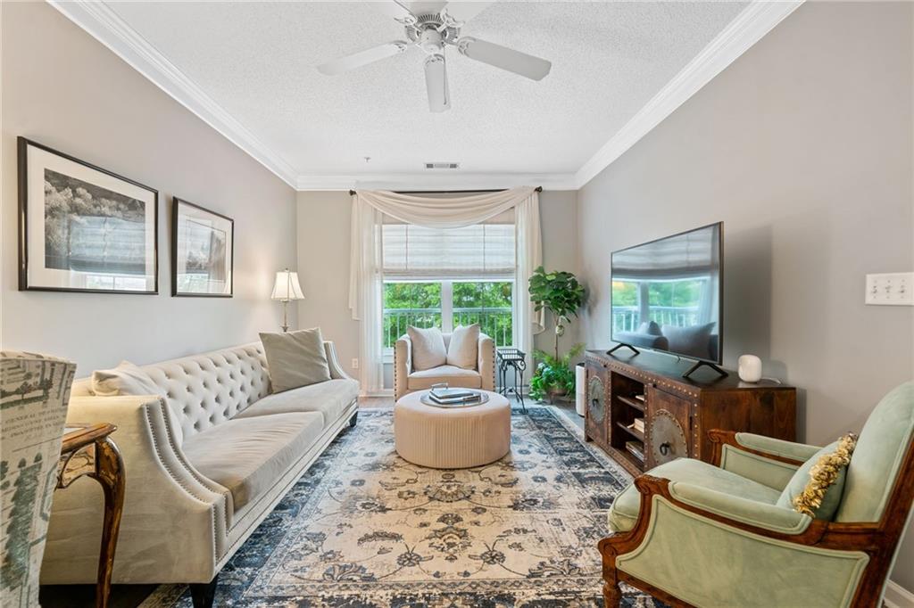 a living room with furniture and a large window