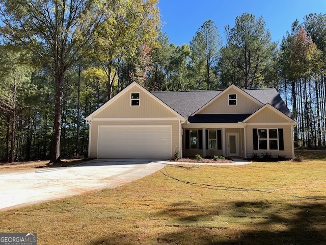 a front view of a house with a yard and trees