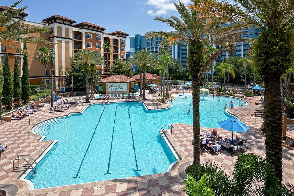 a view of a swimming pool with lounge chairs in patio