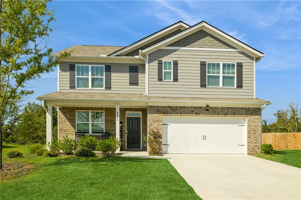 a front view of a house with a yard and garage