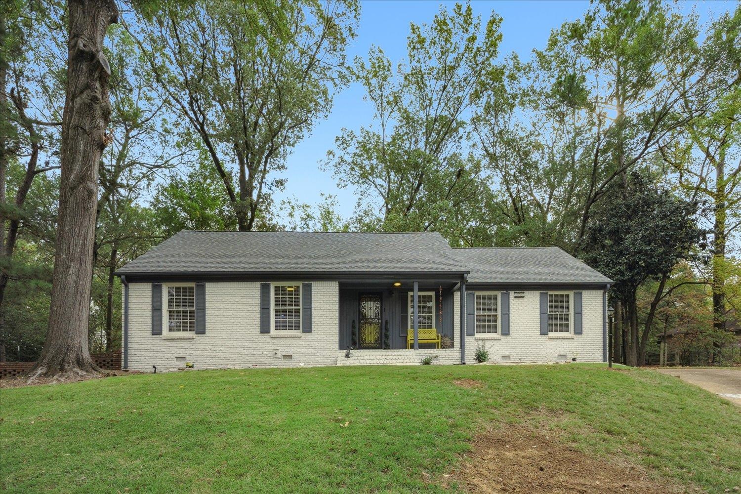 Single story home featuring a front lawn