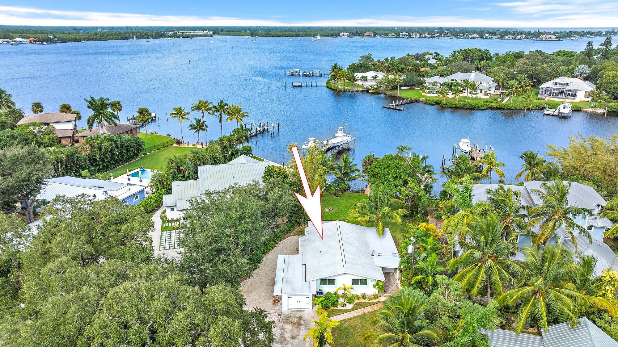 an aerial view of a house with a lake view