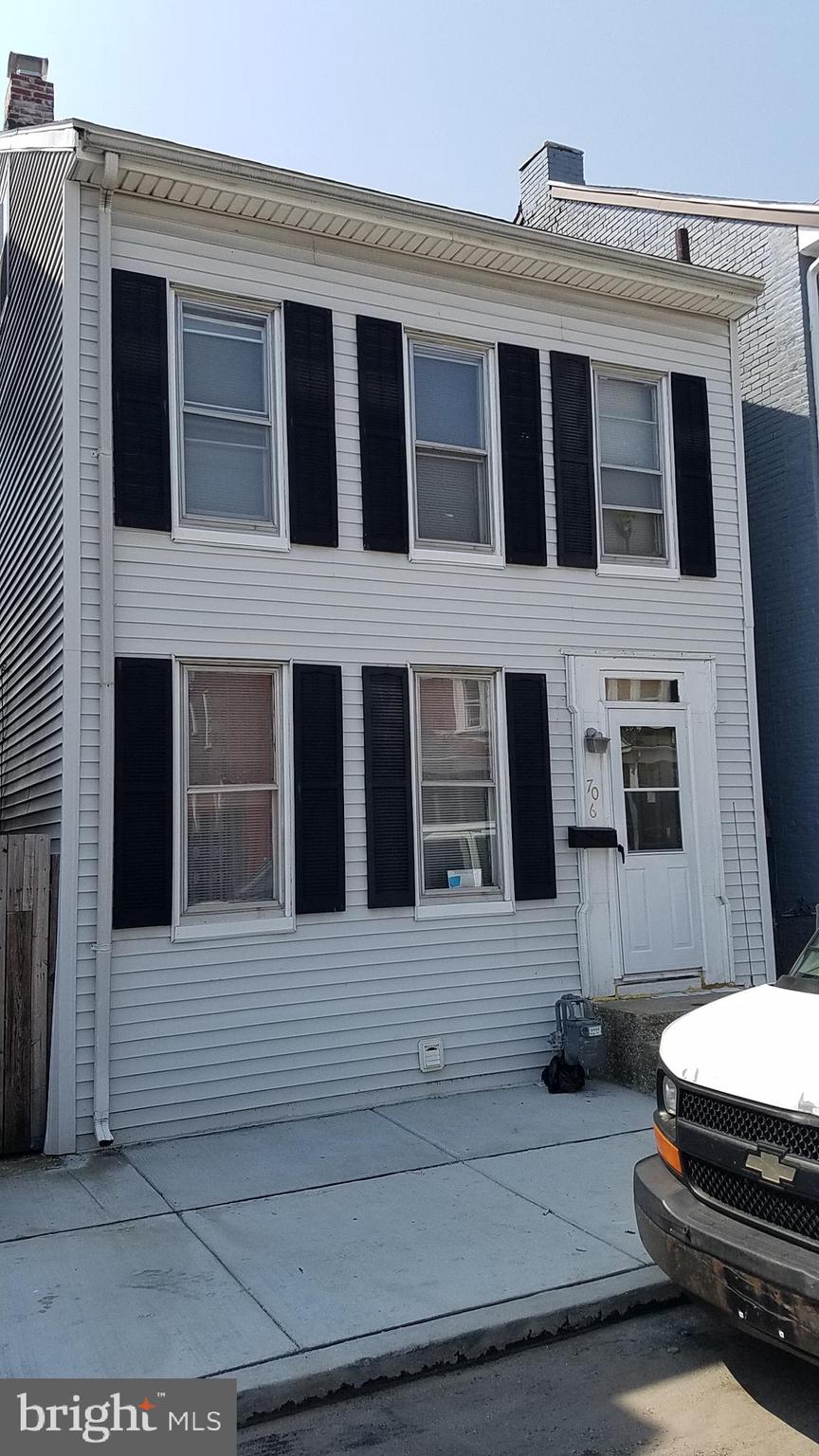 a front view of a house with a parking space