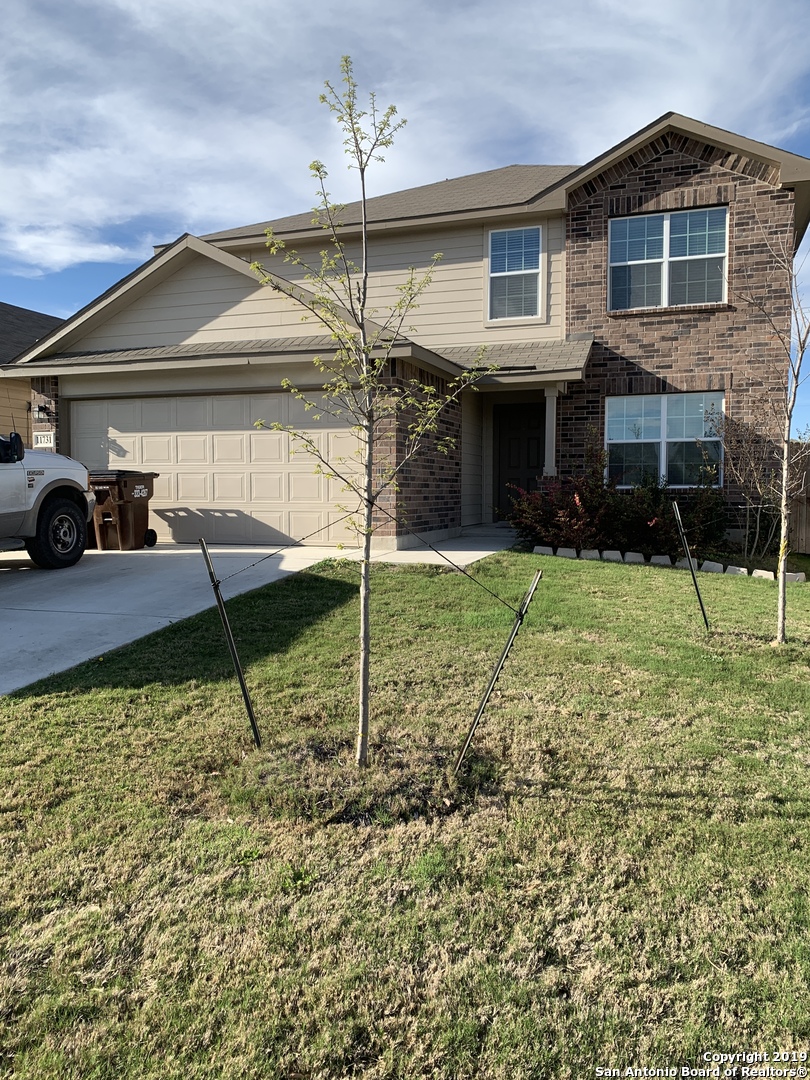 a view of a house with backyard and porch