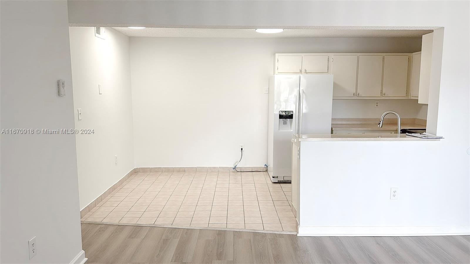 a kitchen with a sink a refrigerator freezer and a dishwasher