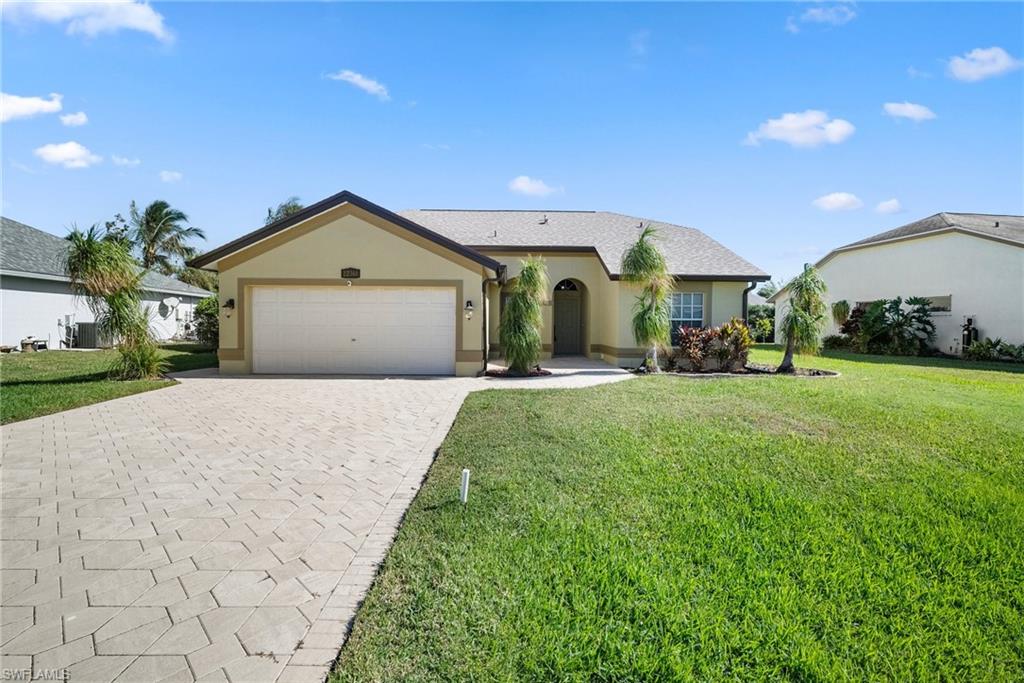 a front view of a house with a yard and garage