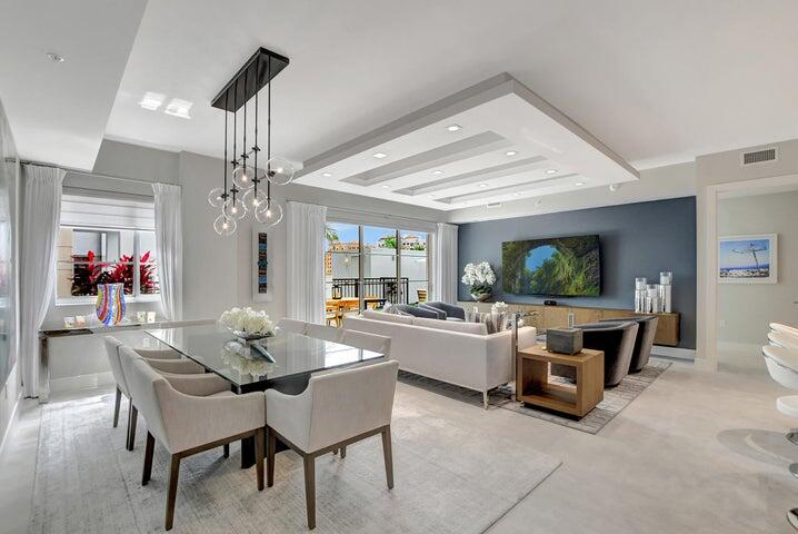 a view of a dining room with furniture and chandelier