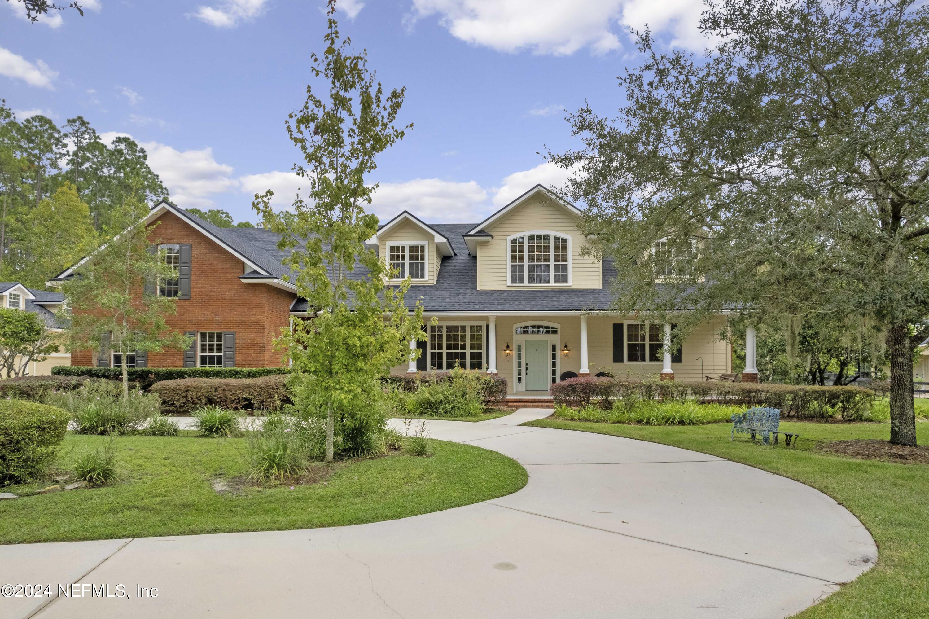 a front view of house with yard and green space