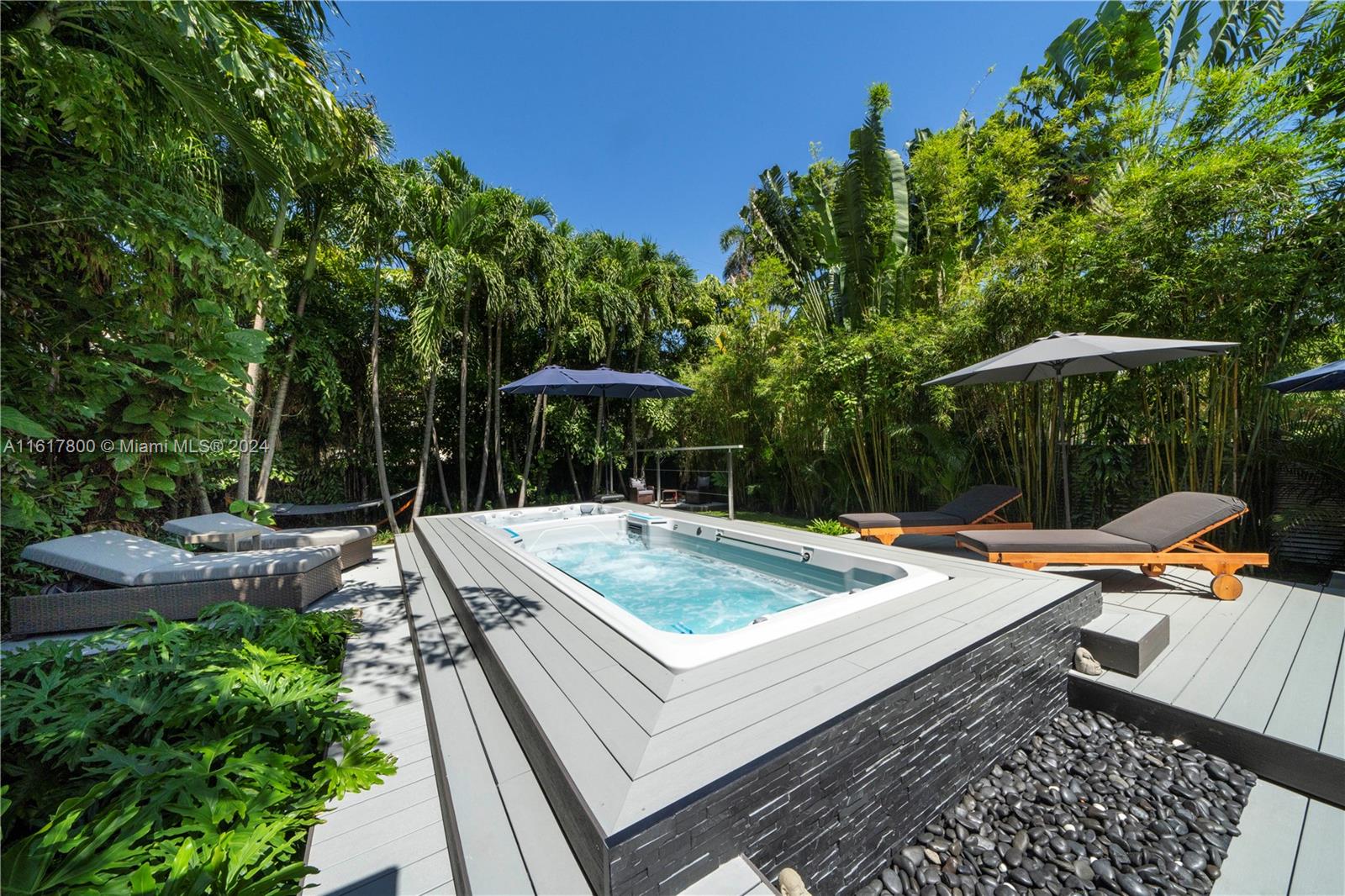 a view of a house with pool and chairs