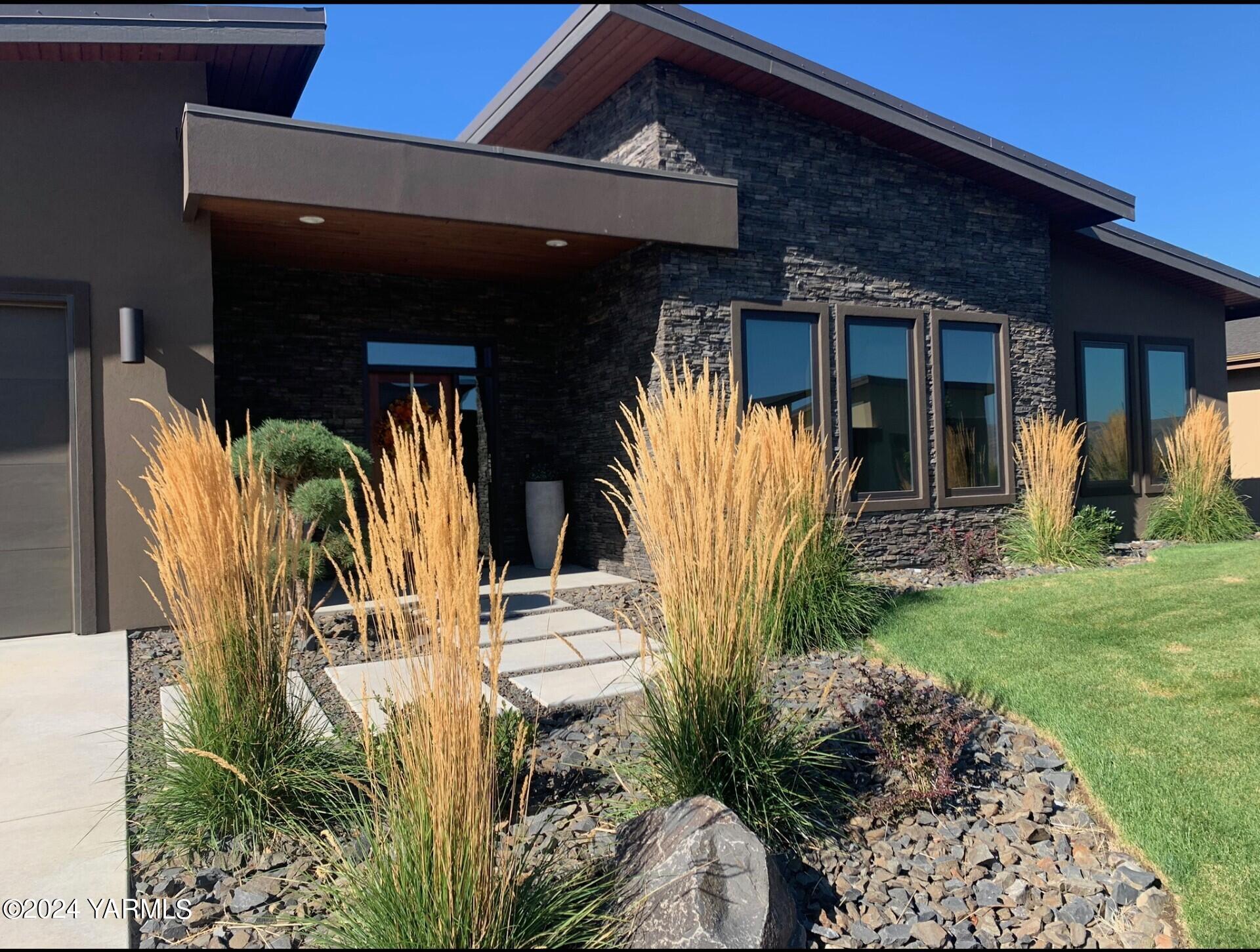 a view of house with backyard and patio