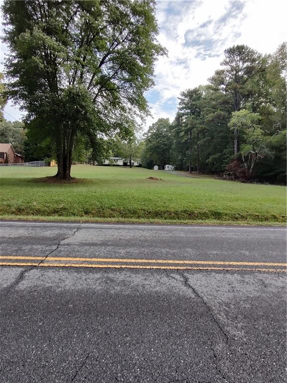 a view of a yard with a large tree