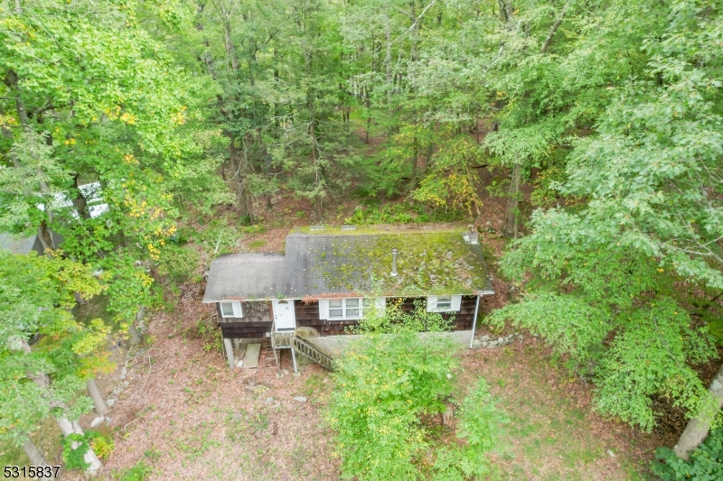 an aerial view of a house with yard and outdoor seating