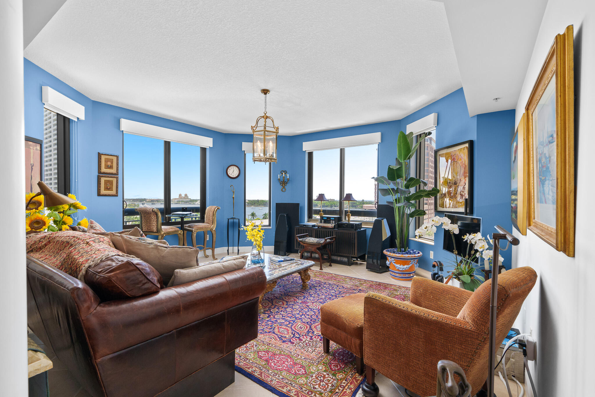 a living room with furniture a couch and a chandelier