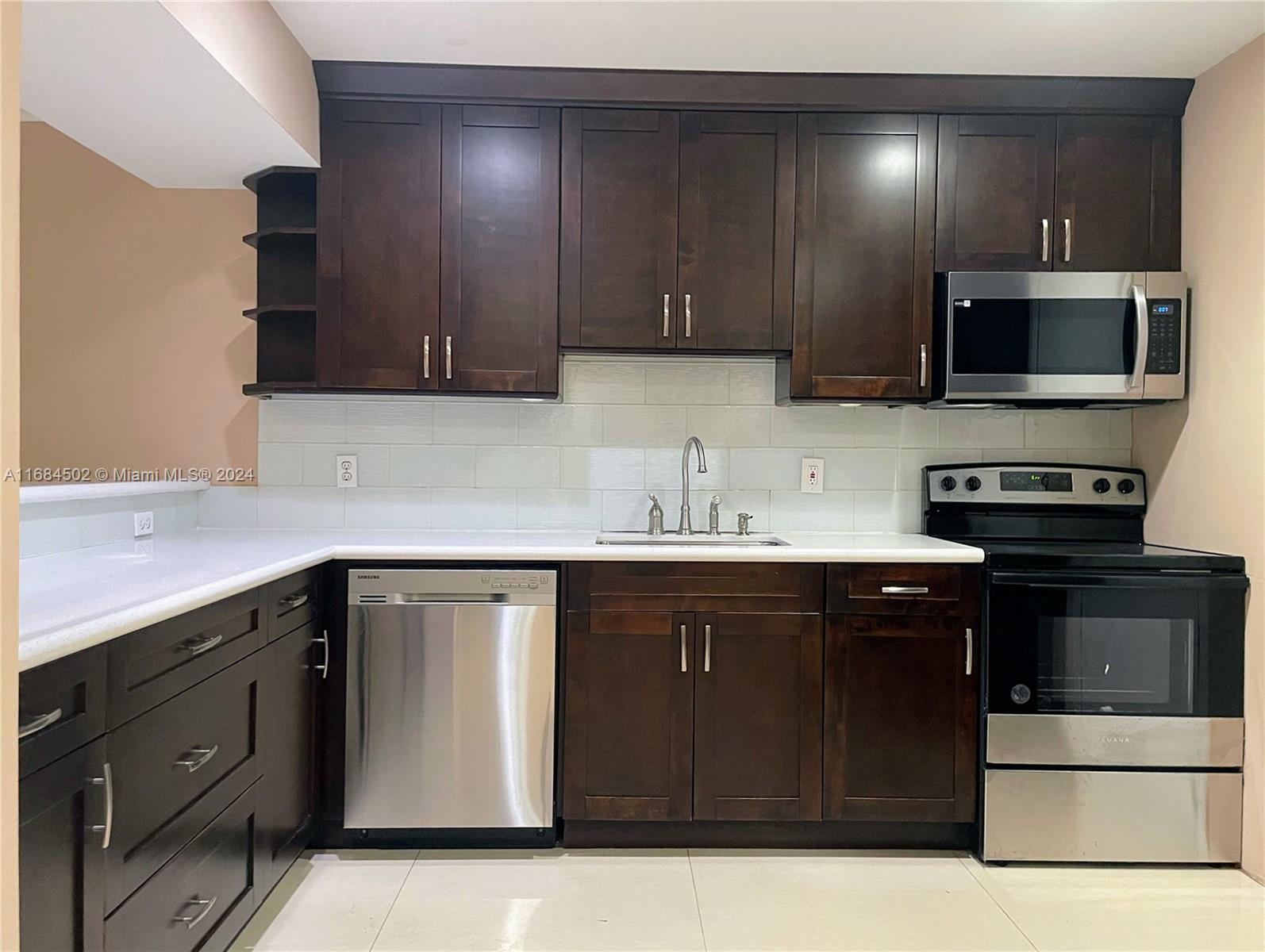 a kitchen with stainless steel appliances granite countertop a sink and a stove