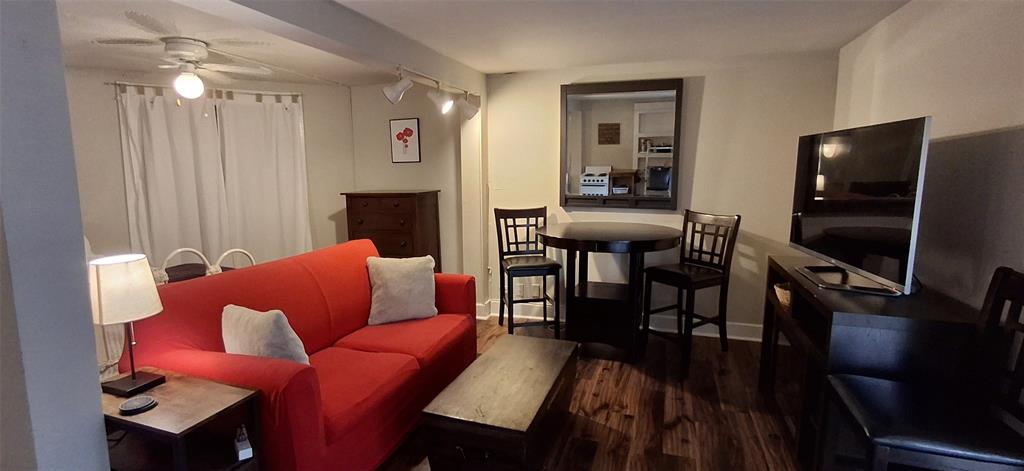 a living room with furniture a dining table and a fireplace