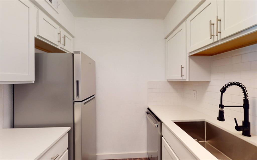 a kitchen with stainless steel appliances cabinets a sink and a window