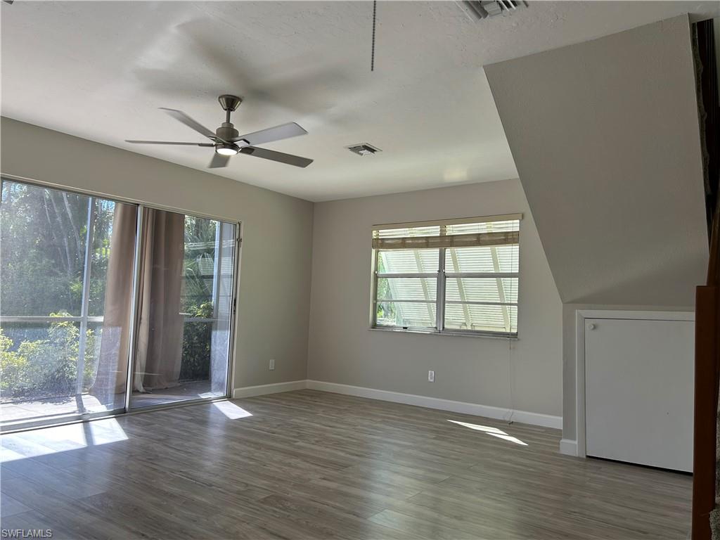 Unfurnished room featuring hardwood / wood-style flooring and ceiling fan