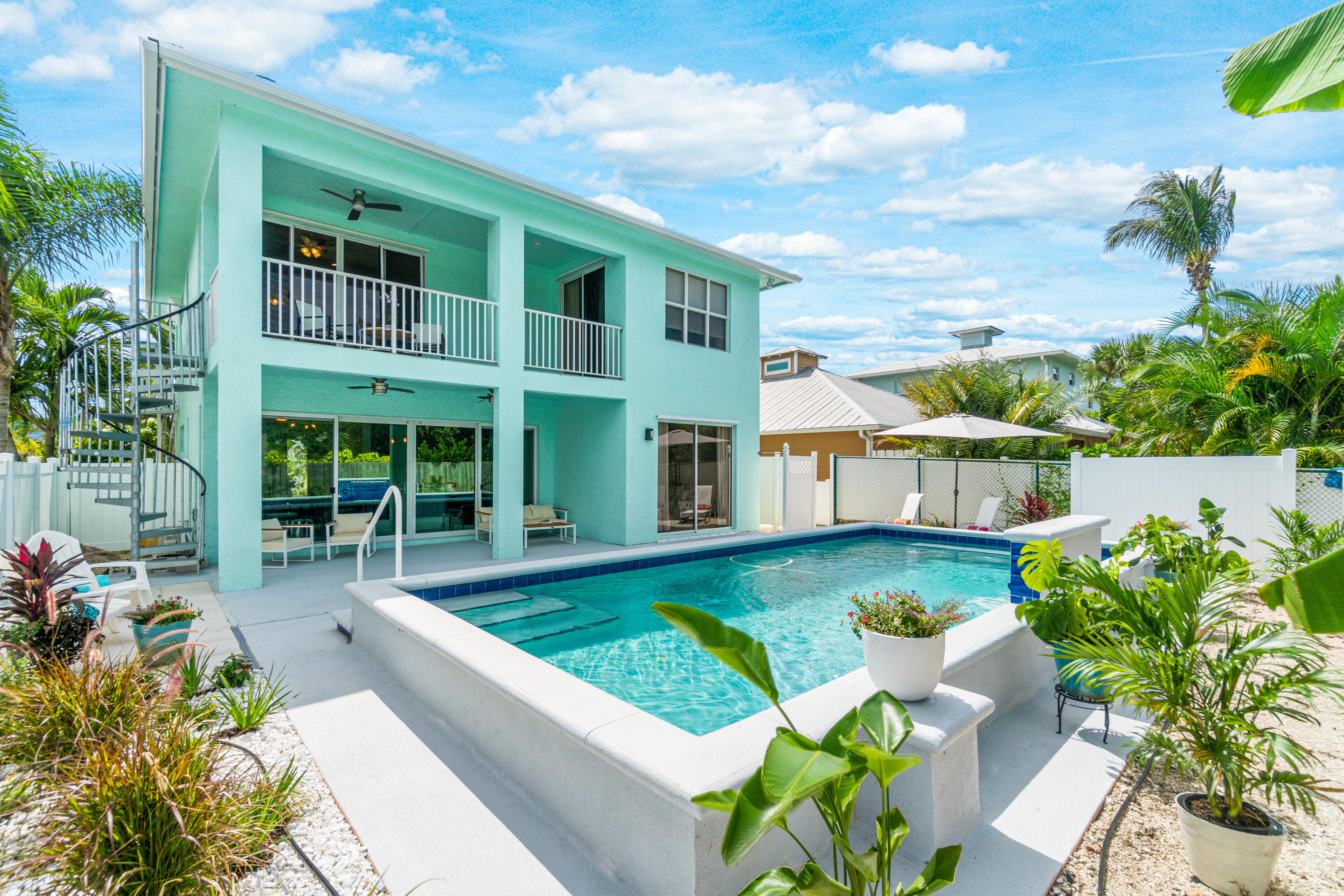 a view of a house with swimming pool in front of it