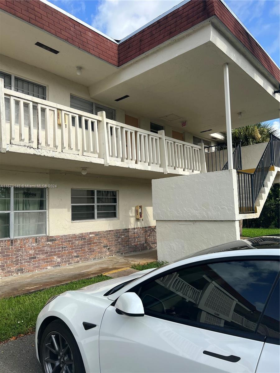 a front view of a house with parking space