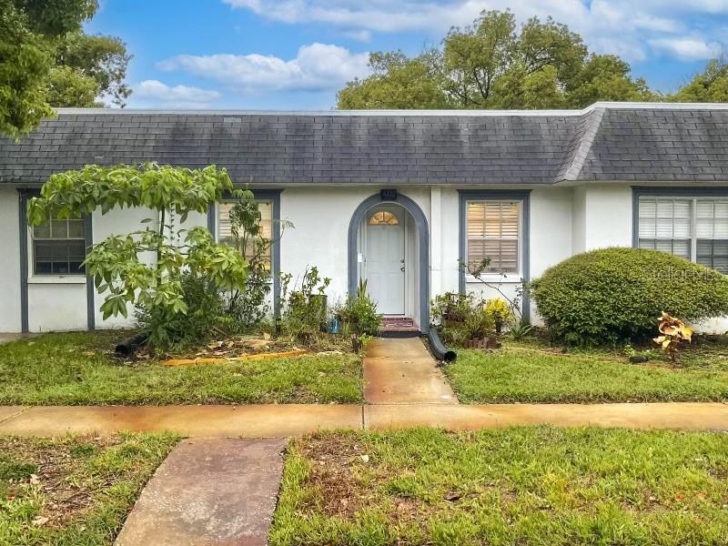 a front view of a house with garden