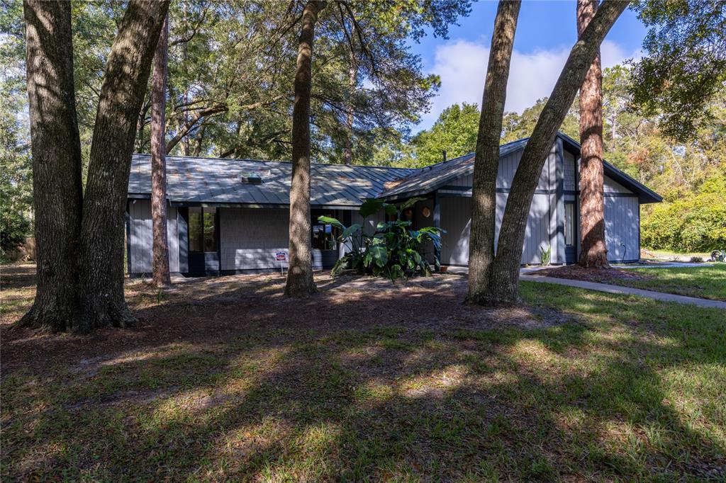 a view of a house with a tree and a yard