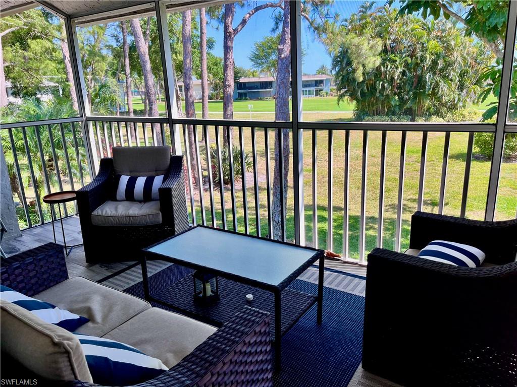 a balcony with furniture and wooden floor