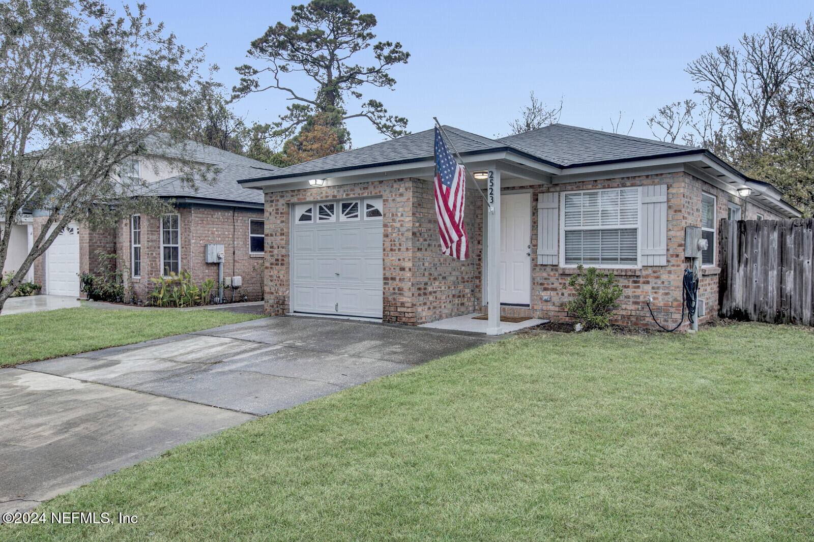 a front view of a house with a garden and yard