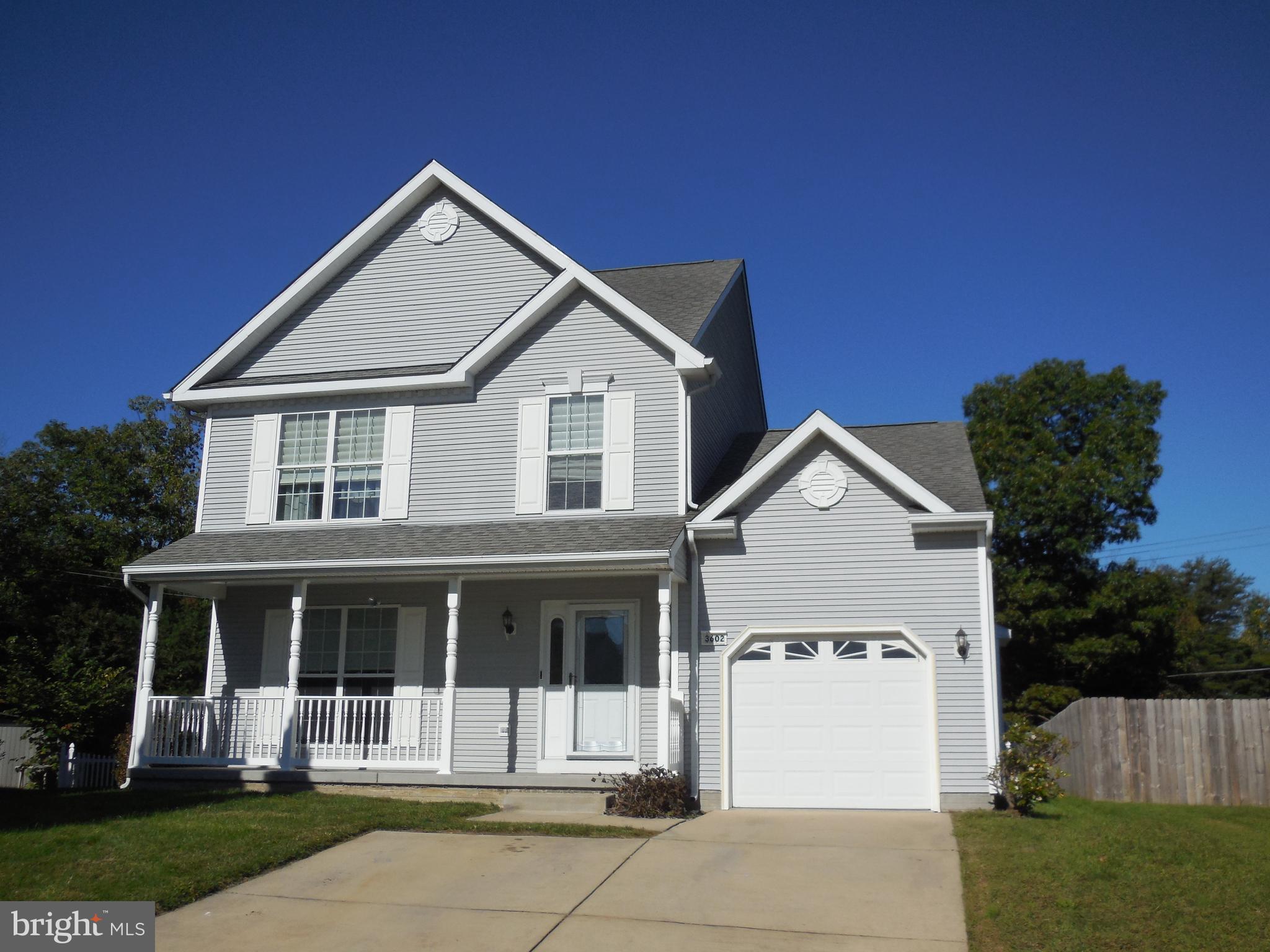 a view of house with yard and green space