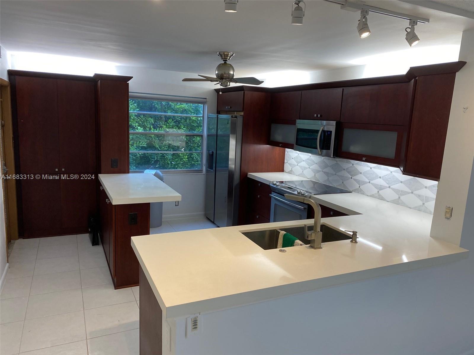 a kitchen with a table and chairs