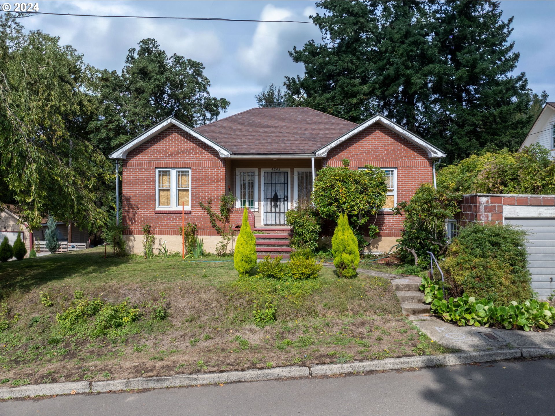 a front view of a house with garden