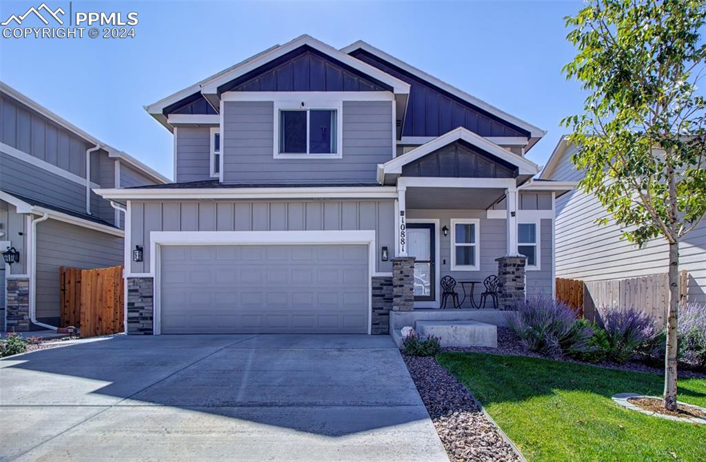 Craftsman-style home with a front lawn and a garage