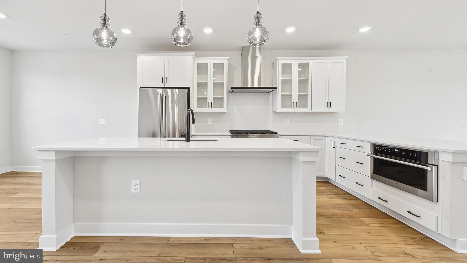 a kitchen with stainless steel appliances granite countertop a sink a stove and a refrigerator