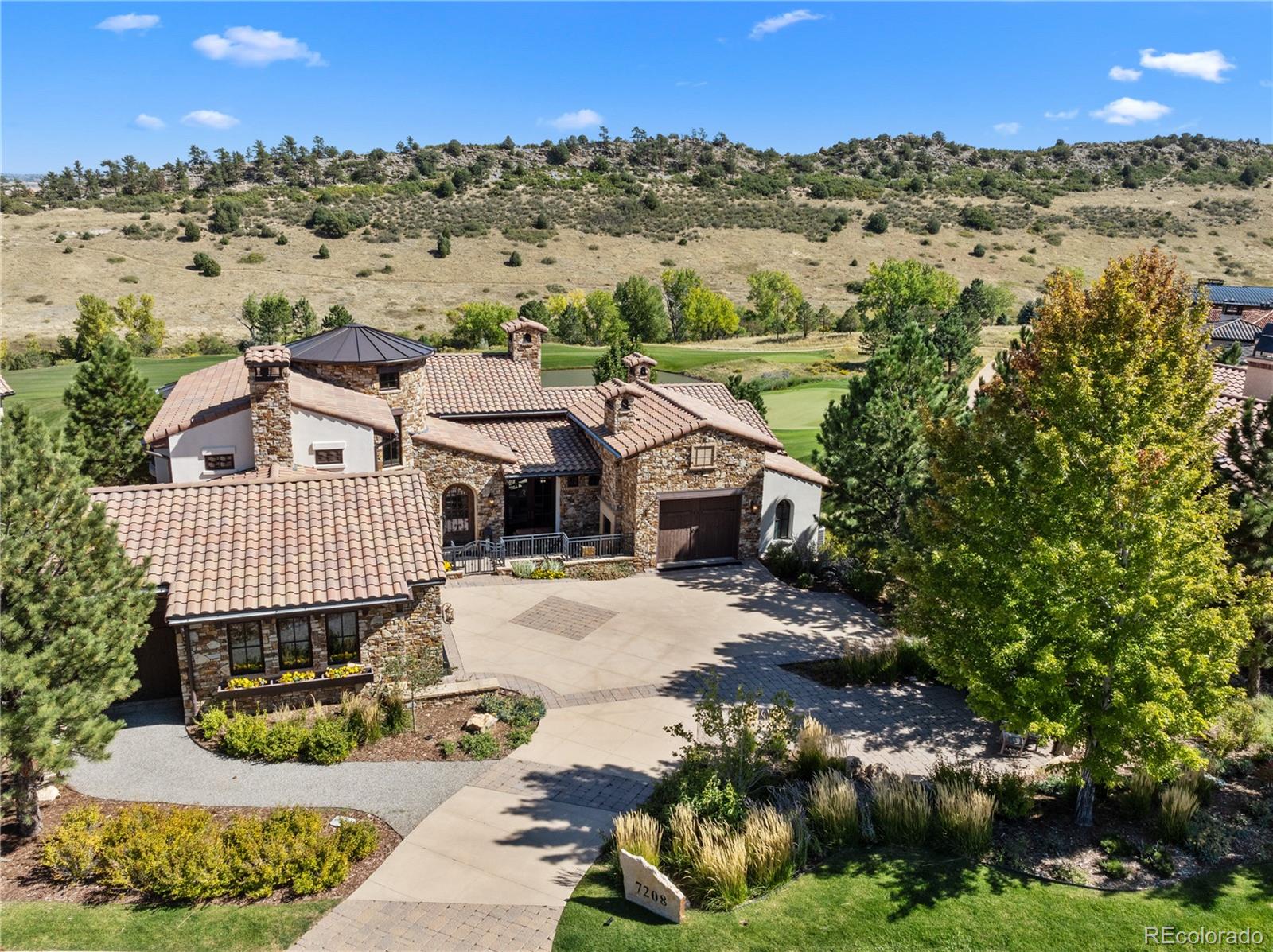 an aerial view of a house with a yard and lake view