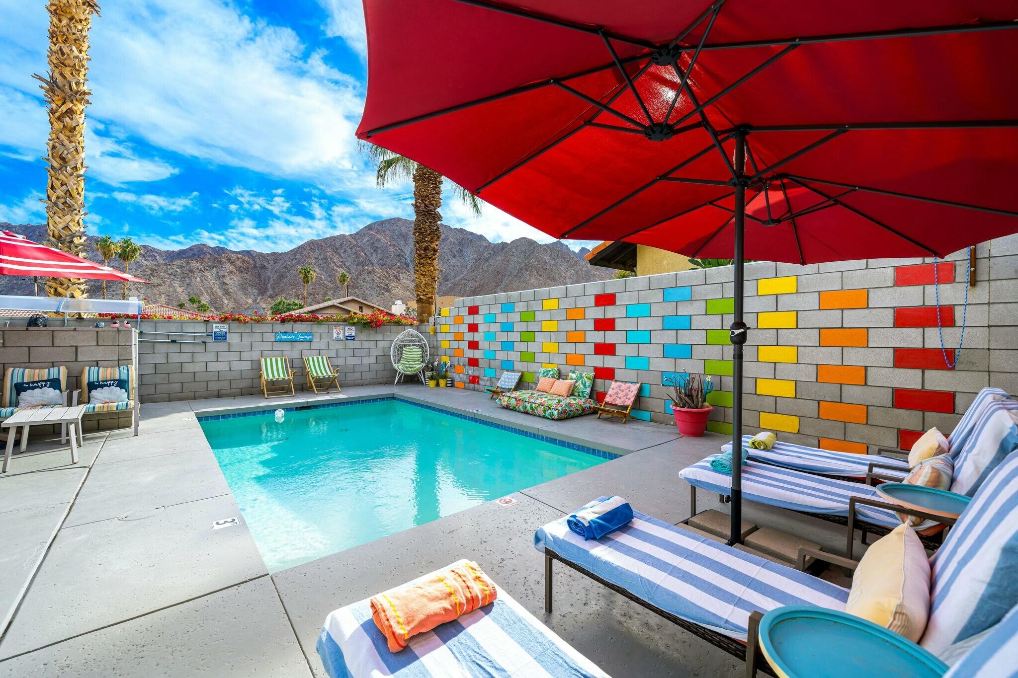 an outdoor sitting area with couch and umbrella