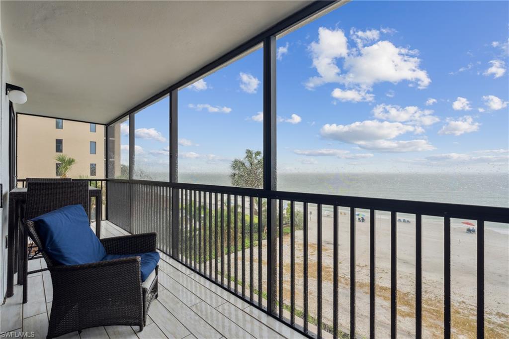 a view of a chairs and table in the balcony