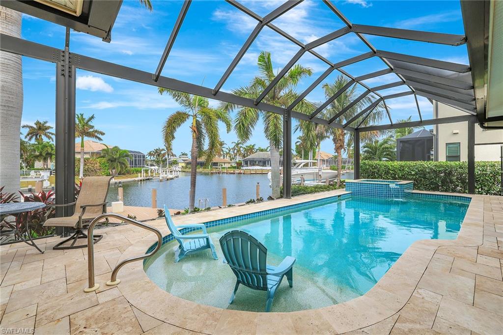 a view of a swimming pool with outdoor seating