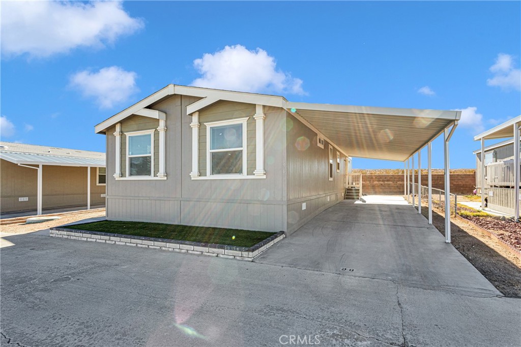 a view of a house with backyard and parking