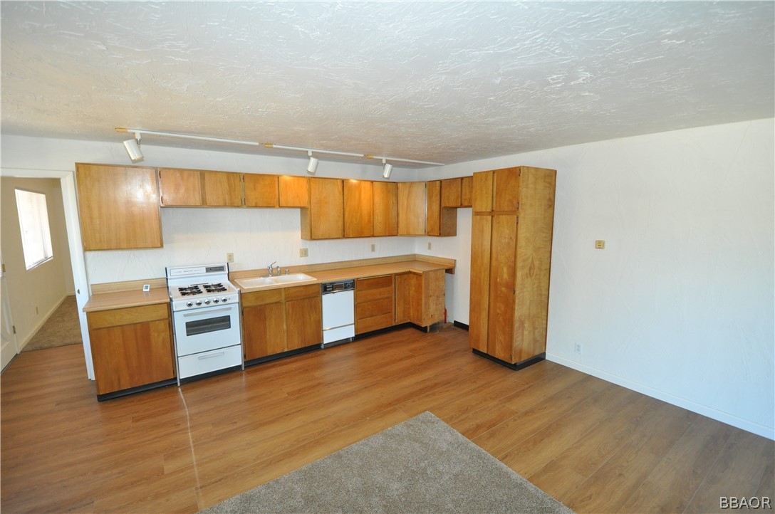 a kitchen with stainless steel appliances a stove a sink and a refrigerator