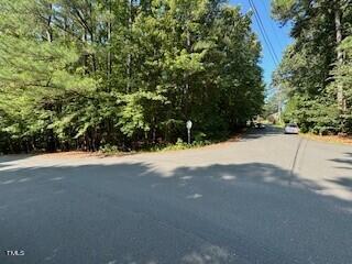 a view of road with large trees