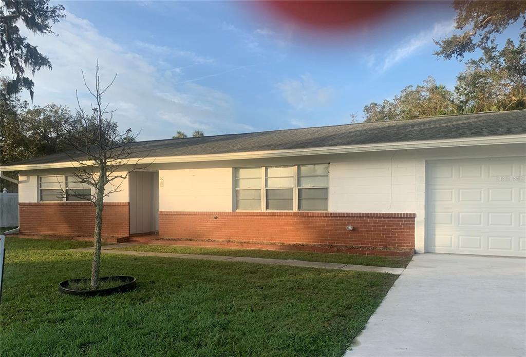 a view of house with backyard