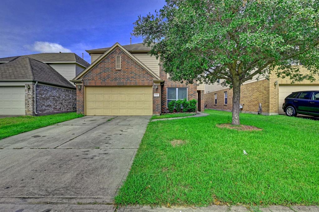 a front view of house with yard and green space