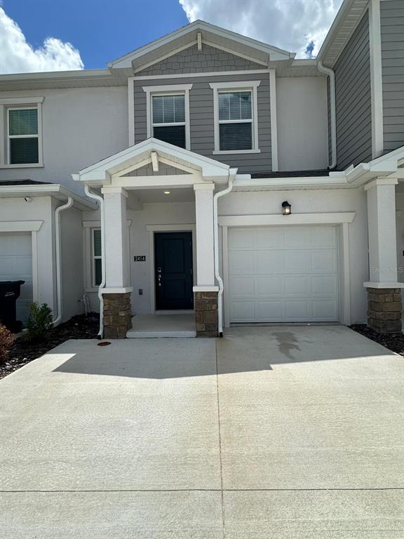 a front view of a house with garage